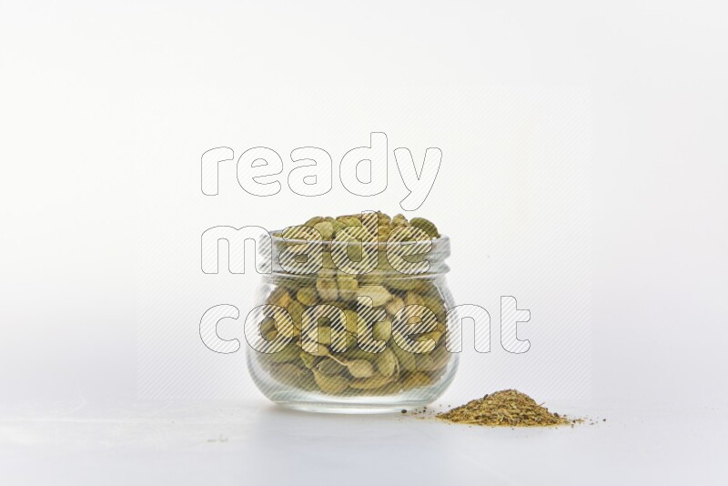 Cardamon in a container on white background