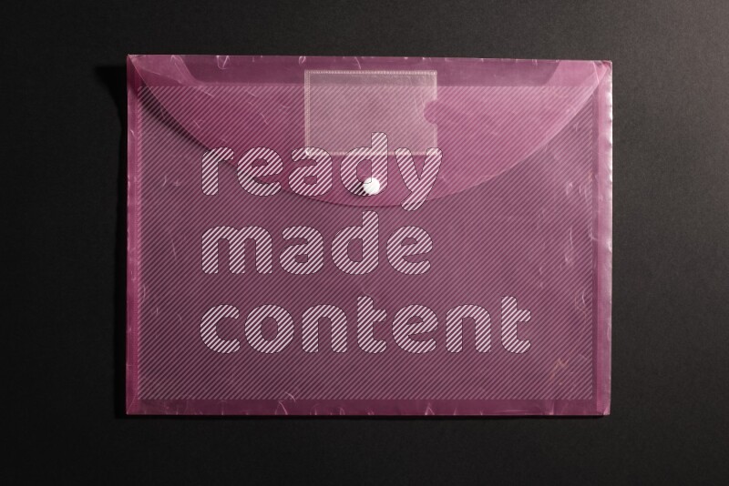 Pink plastic file on black background