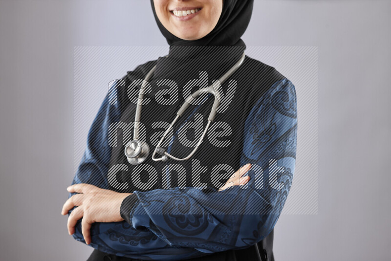 Female doctor wearing an abaya and medical attire in different positions