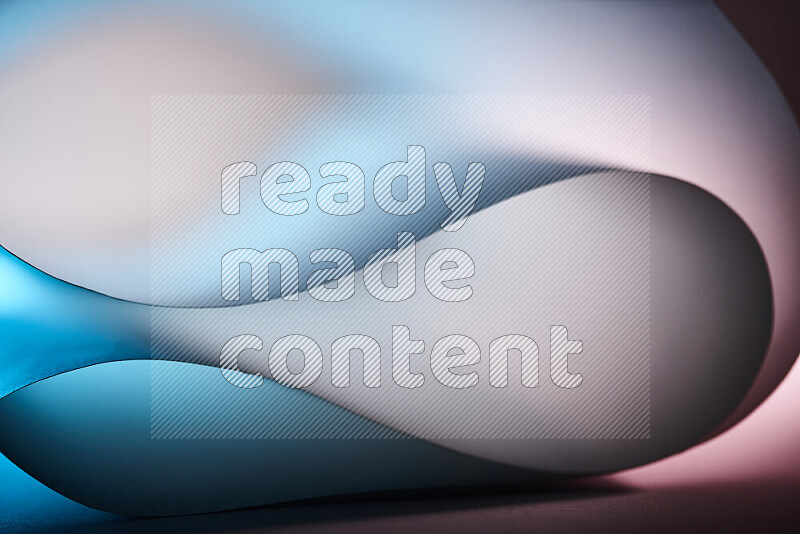 An abstract art piece displaying smooth curves in blue and white gradients created by colored light
