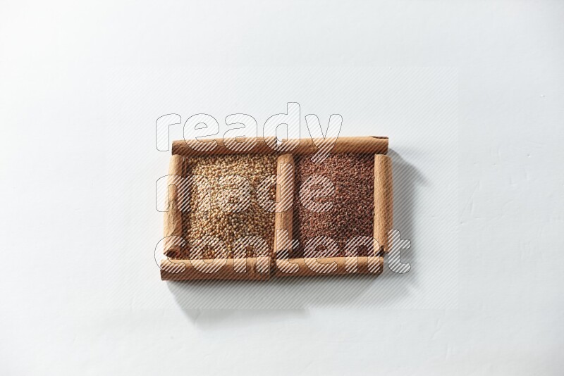 2 squares of cinnamon sticks full of mustard seeds and garden cress on white flooring