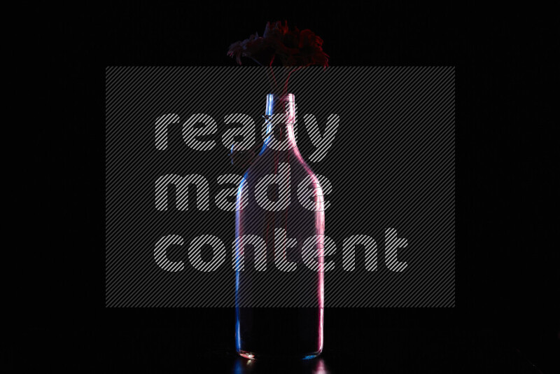 Water bottle with colored rim light against black background