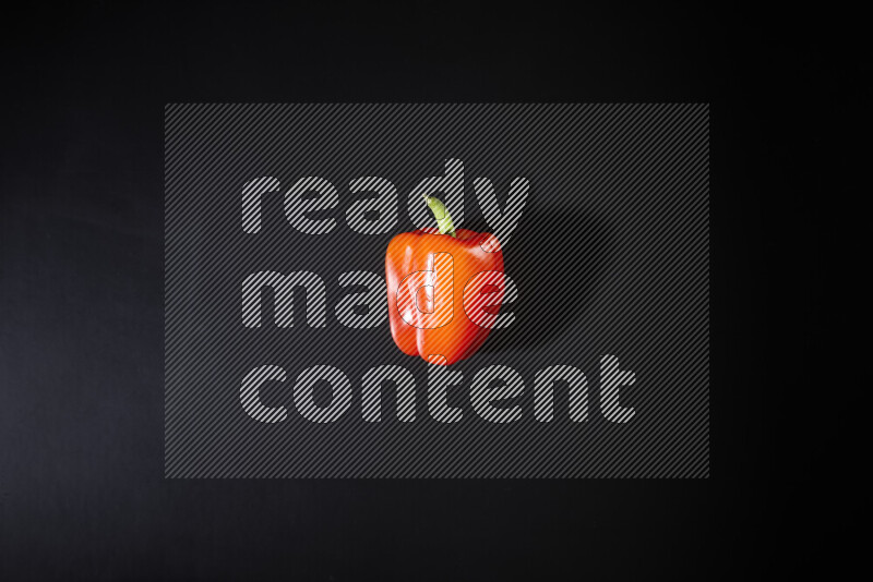 Red bell pepper on black background