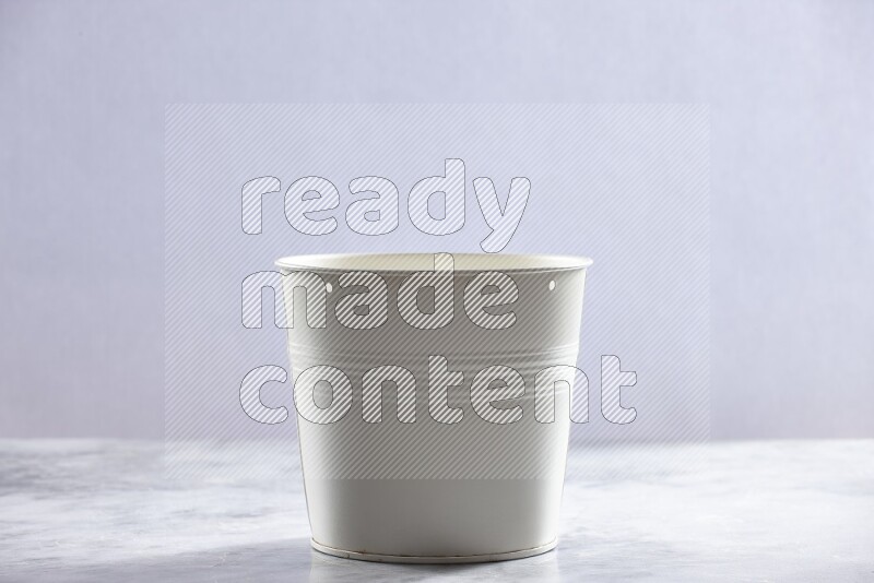 An empty white plant pot on grey marble background
