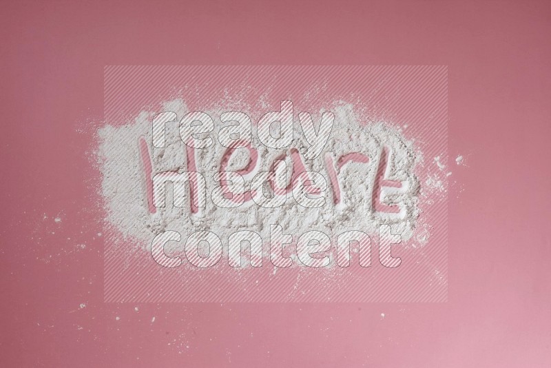 A word written with powder on pink background
