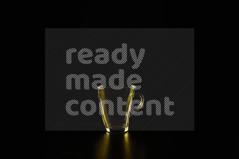 Glassware with rim light in yellow against black background