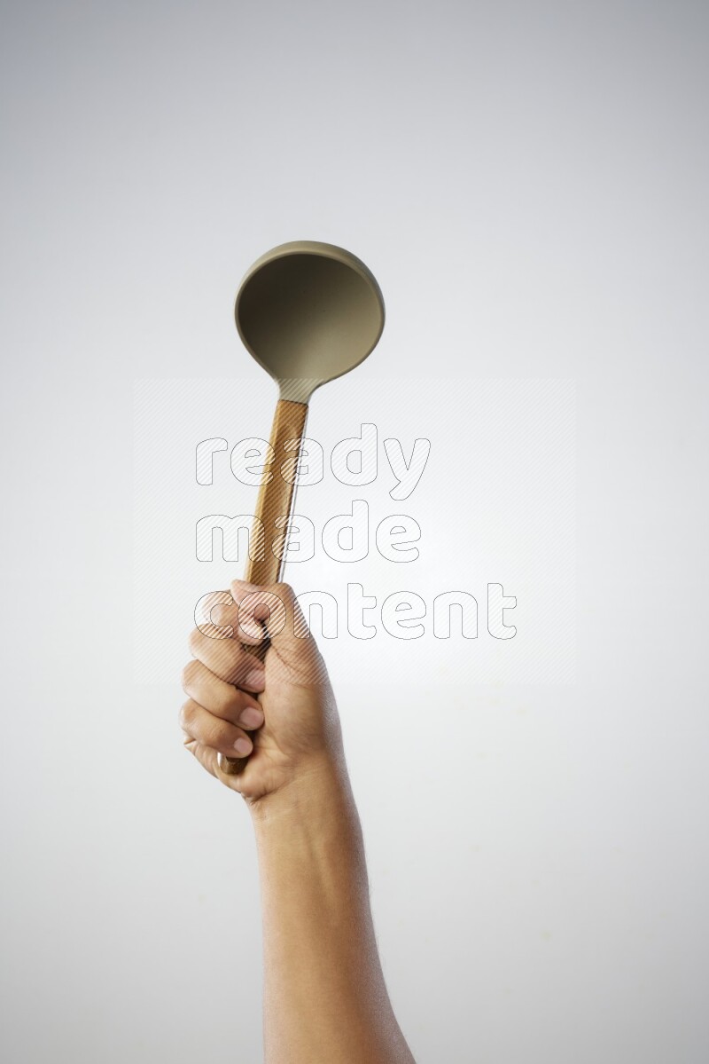 Male Hand Holding ladle on white background