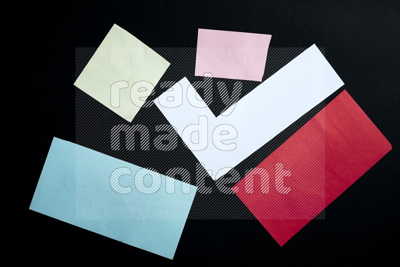 Multicolored paper sheet on black background