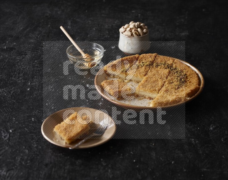 Konafa with nuts and honey in a dark setup