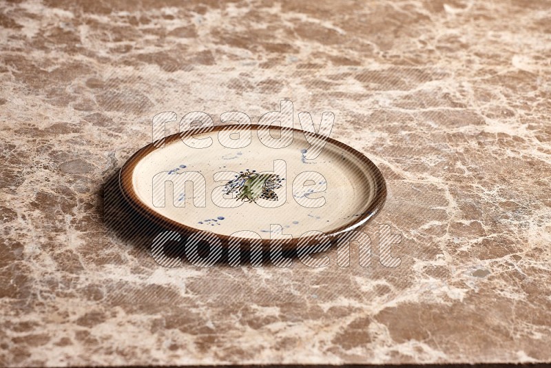 Decorative Pottery Plate on Beige Marble Flooring