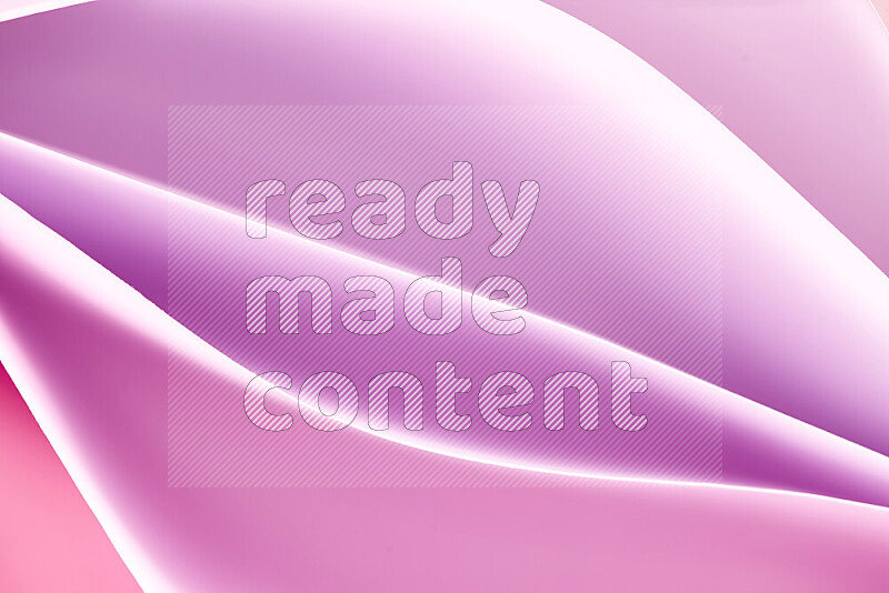 This image showcases an abstract paper art composition with paper curves in purple and pink gradients created by colored light