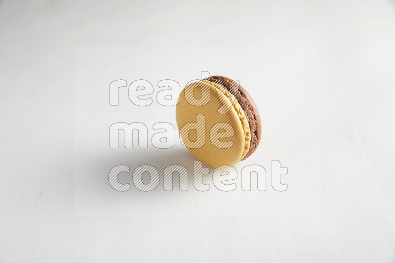 45º Shot of Yellow and Brown Chai Latte macaron on white background