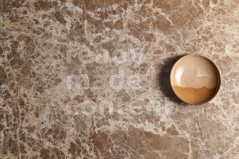 Top View Shot Of A Multicolored Pottery plate On beige Marble Flooring