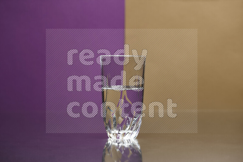 The image features a clear glassware filled with water, set against purple and beige background