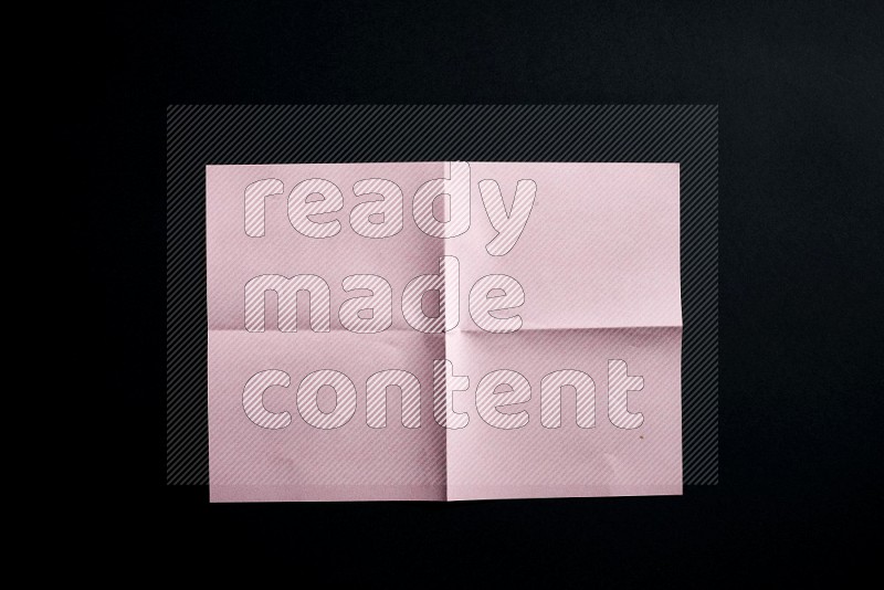 Pink paper sheet on black background