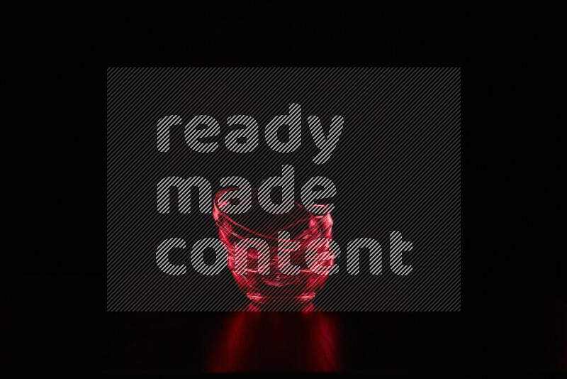 Glassware with rim light in red against black background