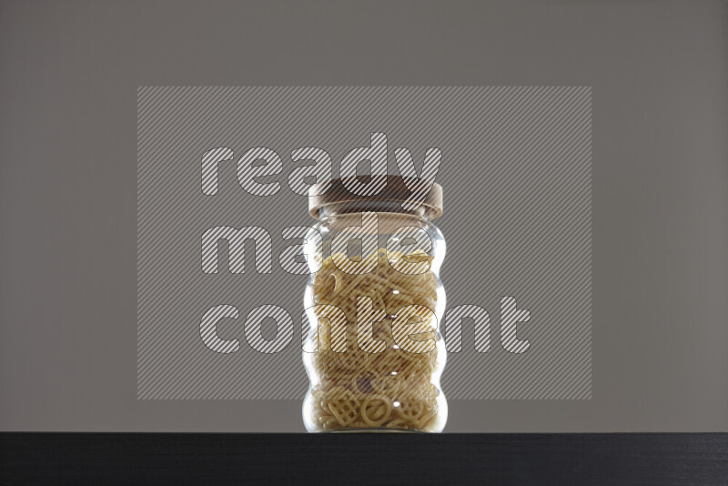 Snacks in a glass jar on black background