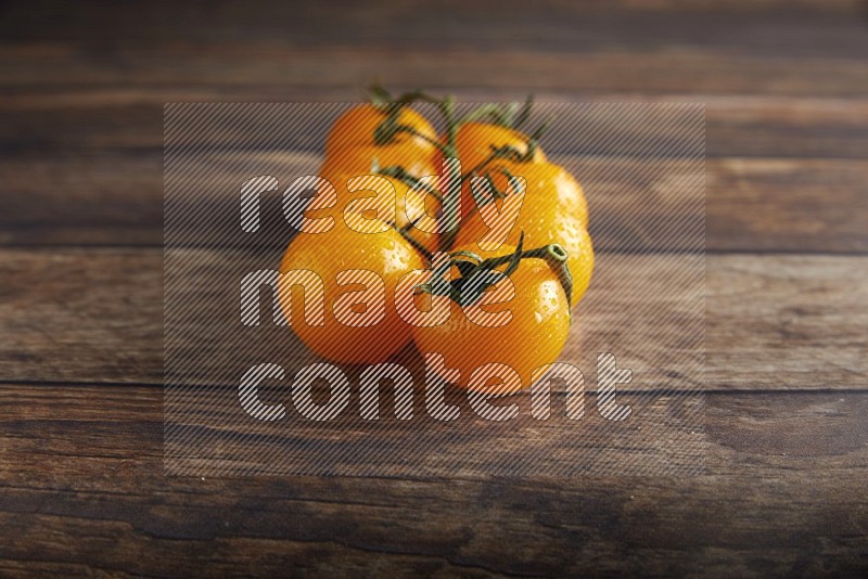 yellow cherry tomato vein on a textured wooden background 45 degree