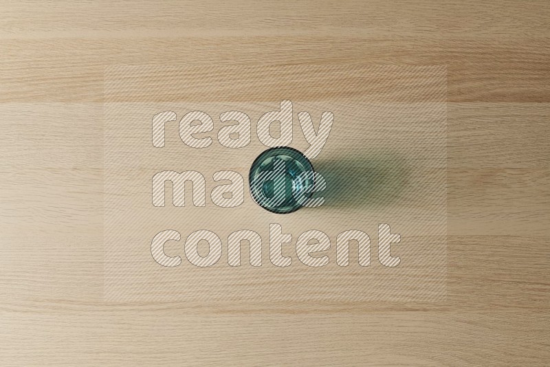 Top View Shot Of A Turquoise Glass on Oak Wooden Flooring