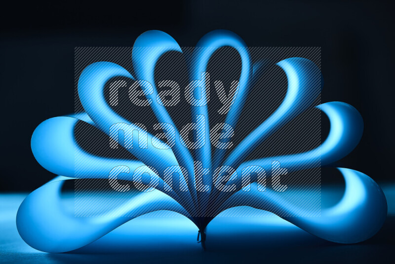 An abstract art piece displaying smooth curves in blue gradients created by colored light