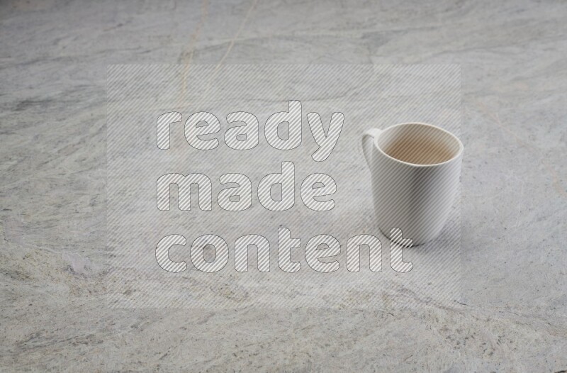 A white ceramic mug on grey marble background