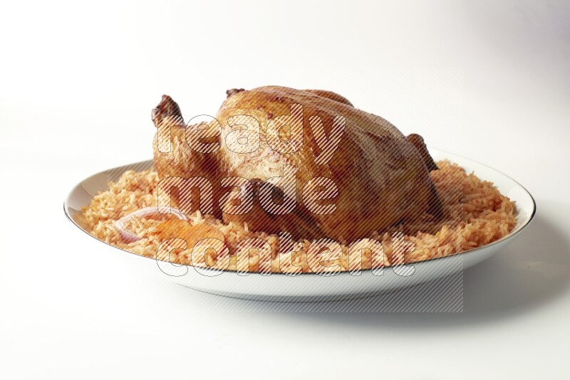 red basmati Rice with whole roasted chicken on a white plate with a silver rim direct on white background