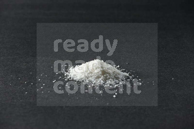 Desiccated coconut on a black background in different angles