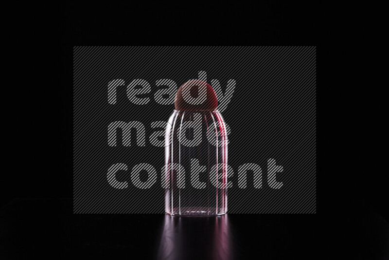 Glassware with rim light in red and white against black background