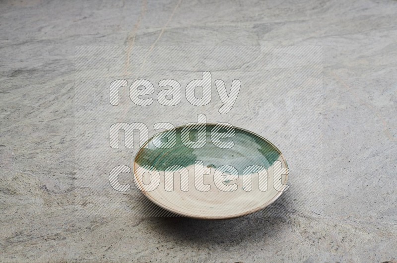 Decorative Pottery Plate On Grey Marble Flooring