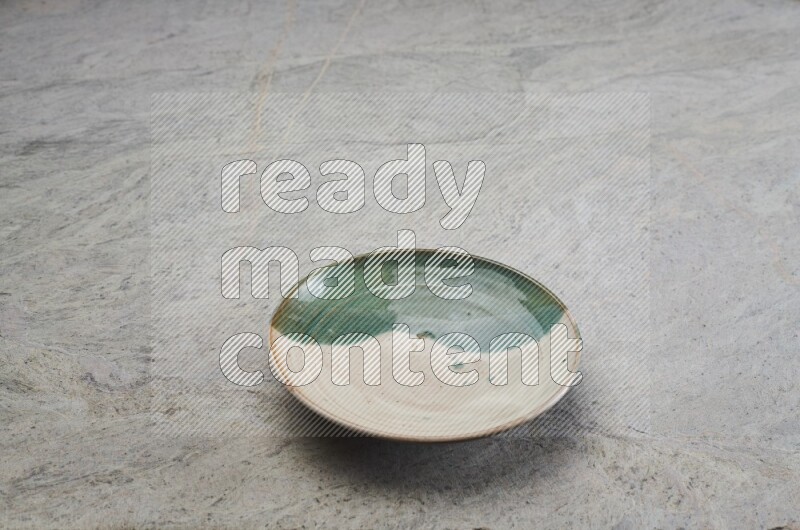 Decorative Pottery Plate On Grey Marble Flooring