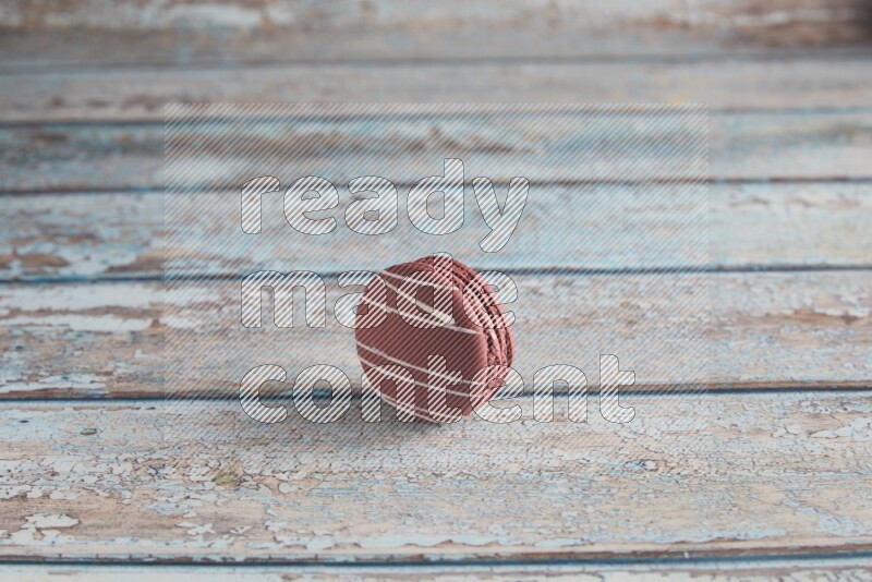 45º Shot of Red Poppy Flower macaron on light blue wooden background