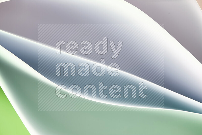 This image showcases an abstract paper art composition with paper curves in green and white gradients created by colored light
