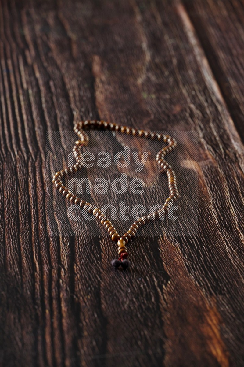 A prayer beads placed on wooden background