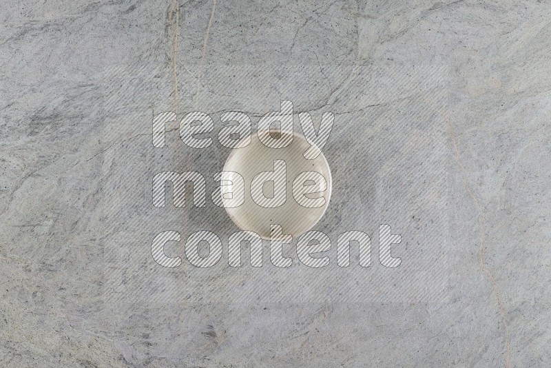 Top View Shot Of A White Pottery Bowl On Grey Marble Flooring