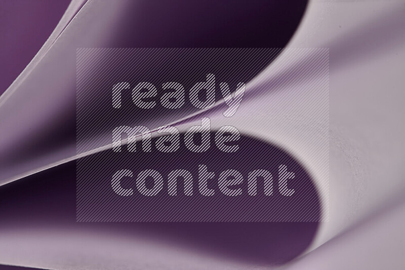An abstract art showing purple paper sheets arranged in an overlapping curves