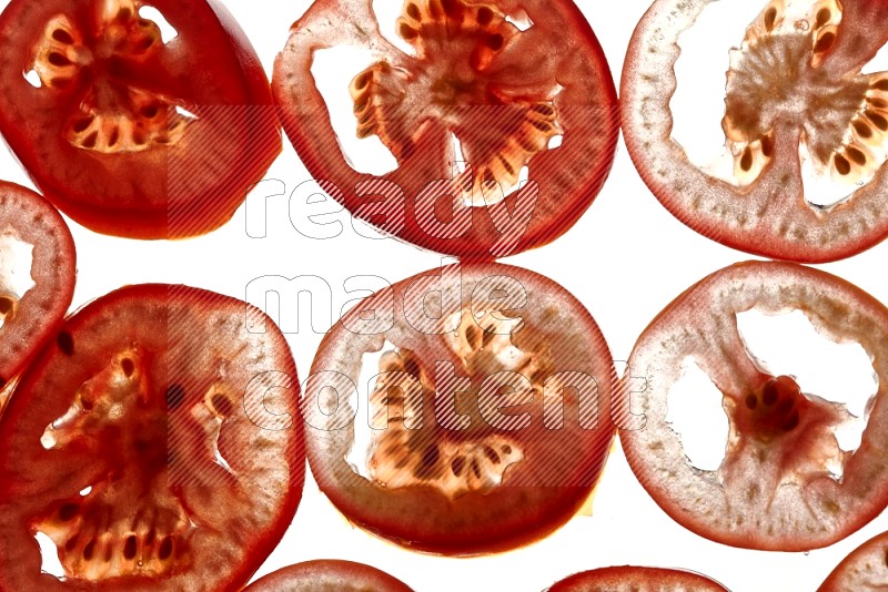 Tomatoes slices on illuminated white background