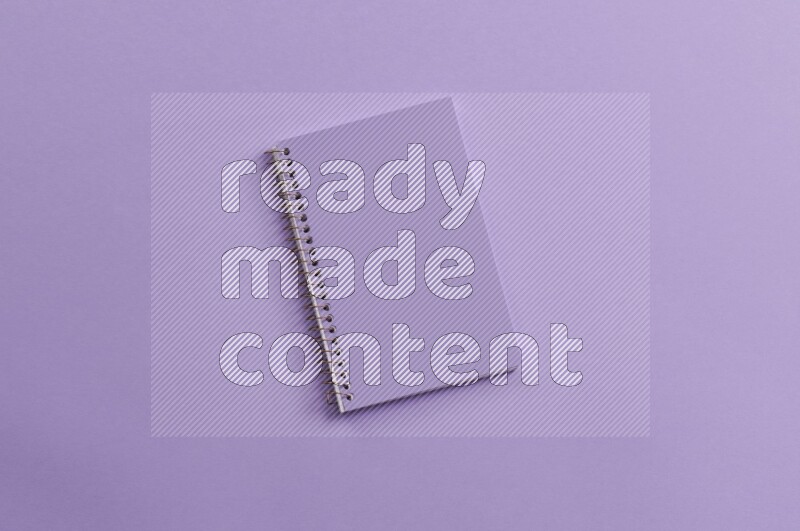 A purple notebook on purple background