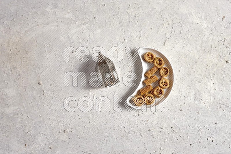 Oriental sweets in a pottery plate with lantern in a light setup