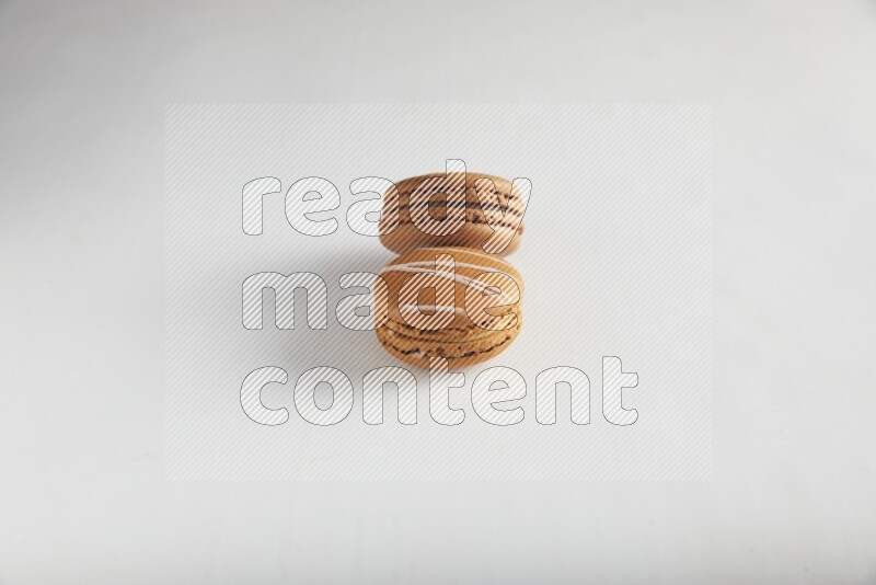 45º Shot of of two assorted Brown Irish Cream, and Brown Coffee macarons  on white background