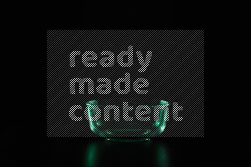 Glassware with rim light in green against black background