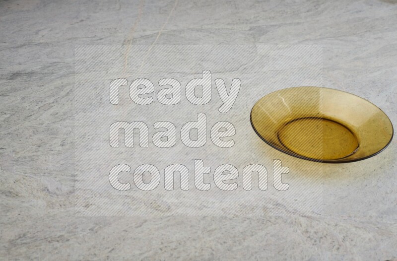 A circular glass plate on grey marble background