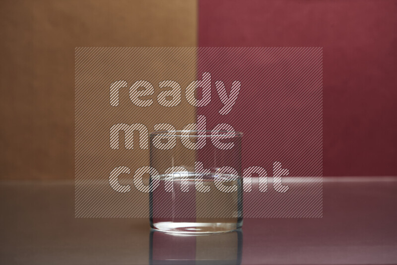 The image features a clear glassware filled with water, set against brown and dark red background