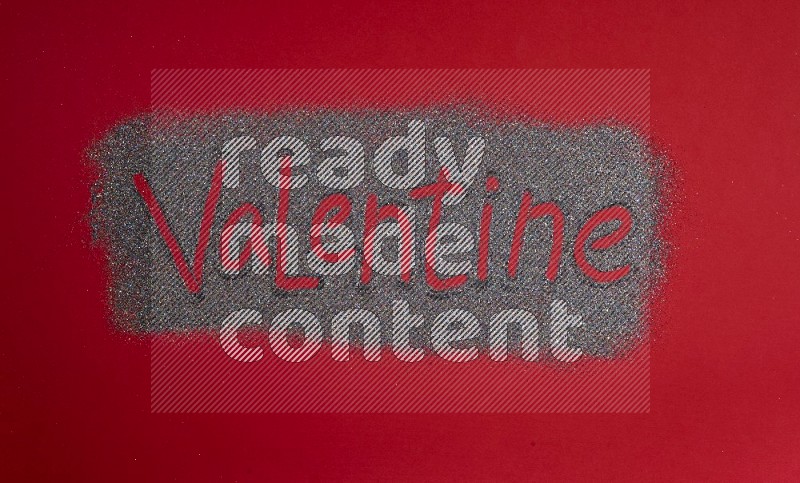 A word written with glitter on red background