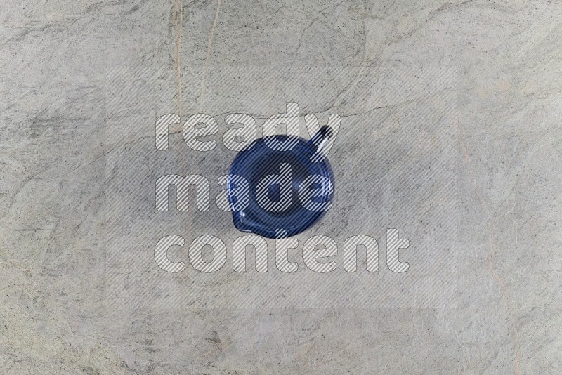 Top View Shot Of An Empty Glass Jug On Grey Marble Flooring