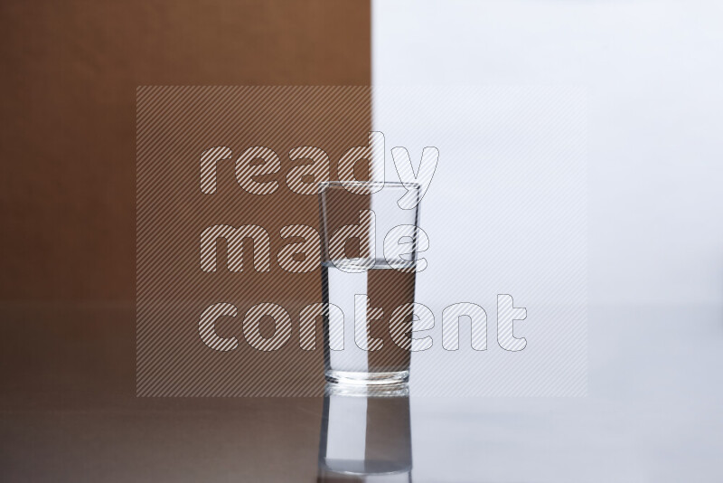 The image features a clear glassware filled with water, set against white and brown background