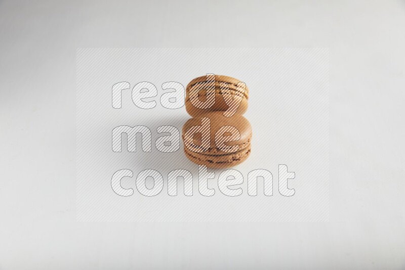 45º Shot of of two assorted Brown Irish Cream, and Brown Coffee macarons  on white background