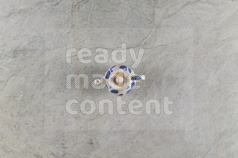 A pottery teapot on grey marble background
