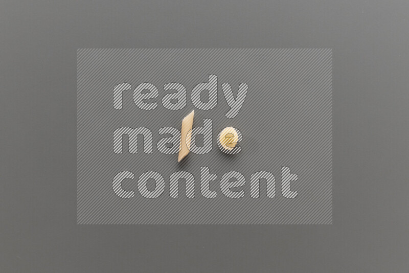 Mini penne pasta with other types of pasta on grey background