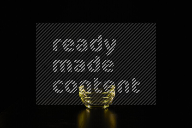 Glassware with rim light in yellow against black background