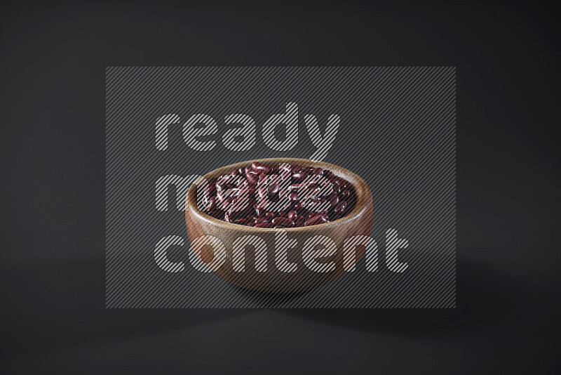 Red kidney beans in a wooden bowl on grey background